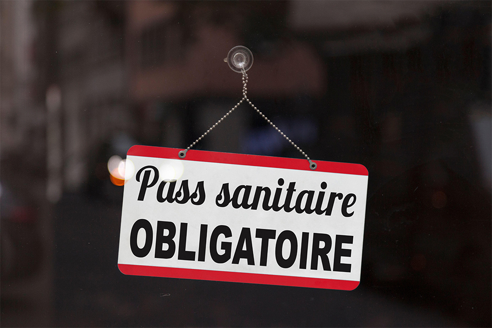 A sign in a window in France that translates in English to ‘Compulsory health pass’ (photograph by Christophe Coat/Alamy)